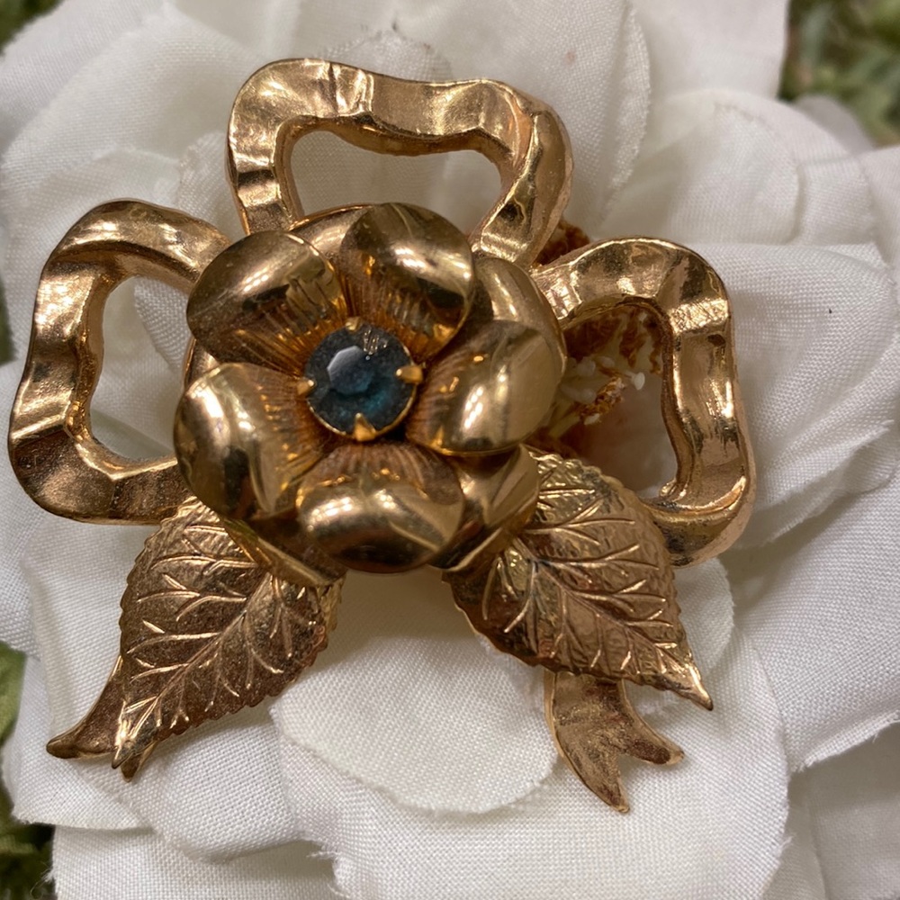 Vintage Coro rose and bow gold metal brooch with blue center rhinestone 2 1/4”
